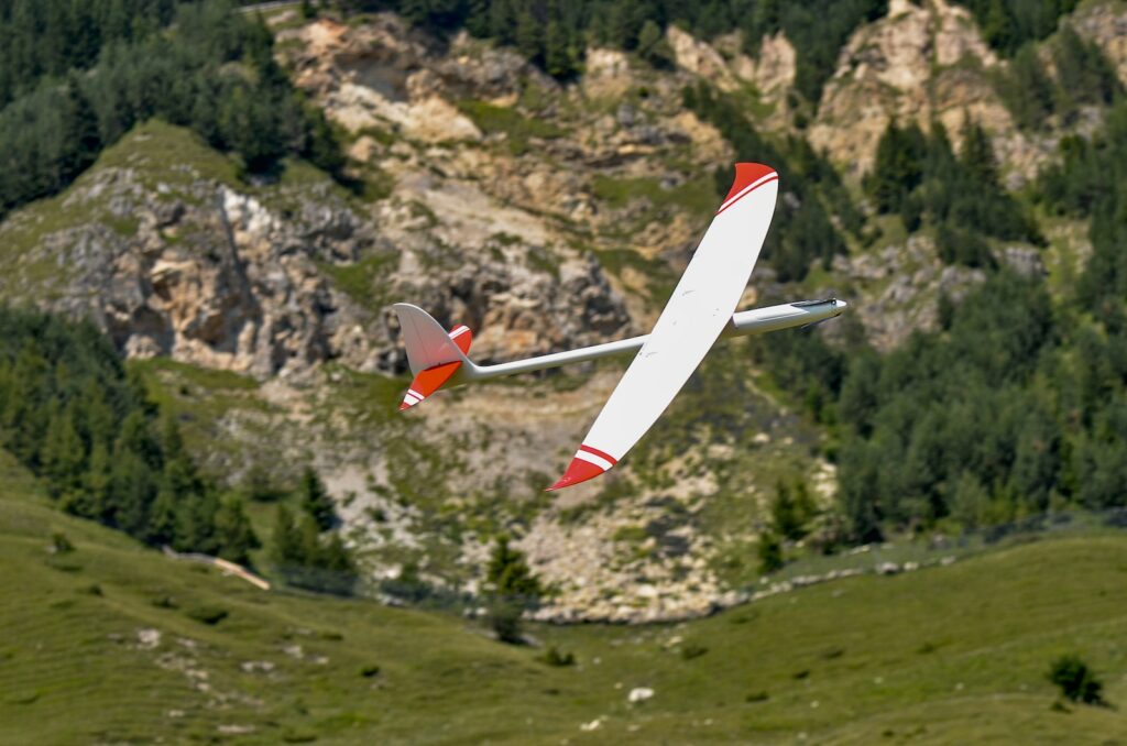 red and white toy plane in the sky